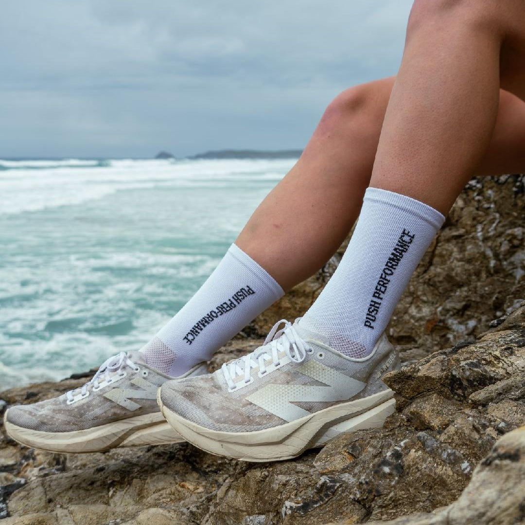 White performance running socks on foot side view.