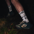 push performance white camo anti-blister running socks being worn by a runner at night time. 
