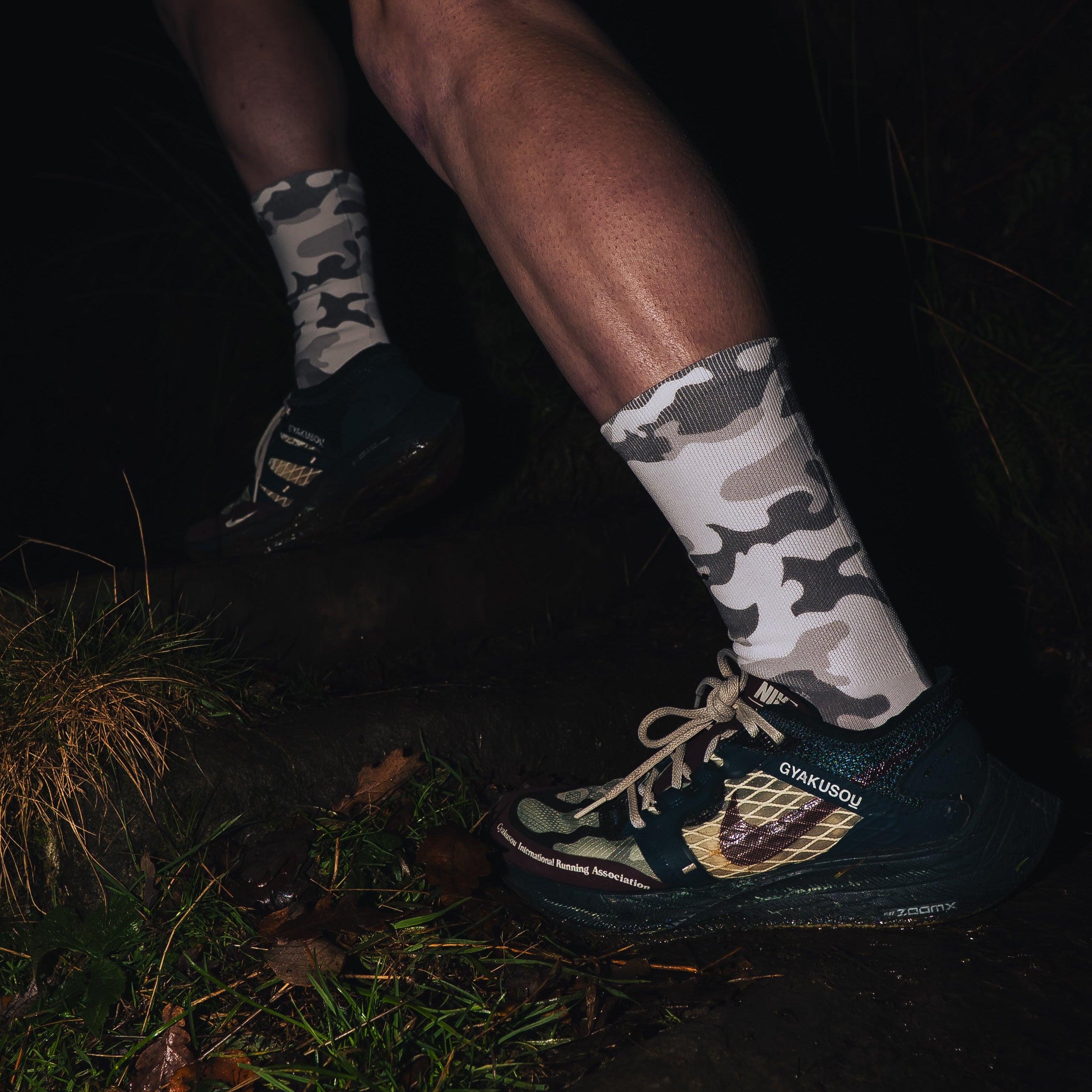 push performance white camo anti-blister running socks being worn by a runner at night time. 