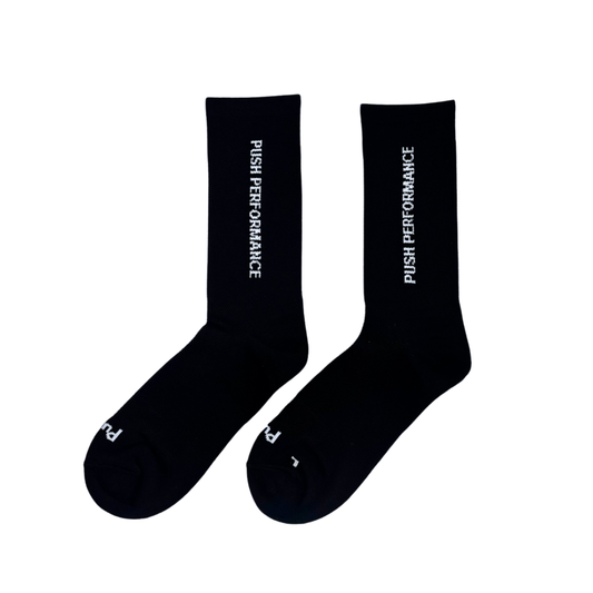 Black performance running socks flat lay.