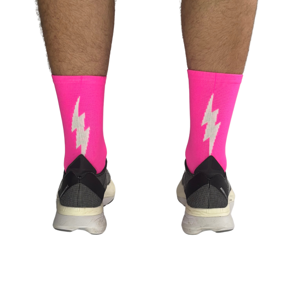 Hot pink running socks showcasing breathable mesh panels.