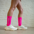 Athlete wearing hot pink Essential Endurance Socks, engineered for performance, grip and long-distance comfort