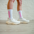 Runner wearing white and hot pink Essential Endurance Socks by Push Performance, designed for comfort and grip