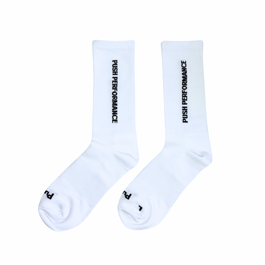 White performance running socks flat lay.