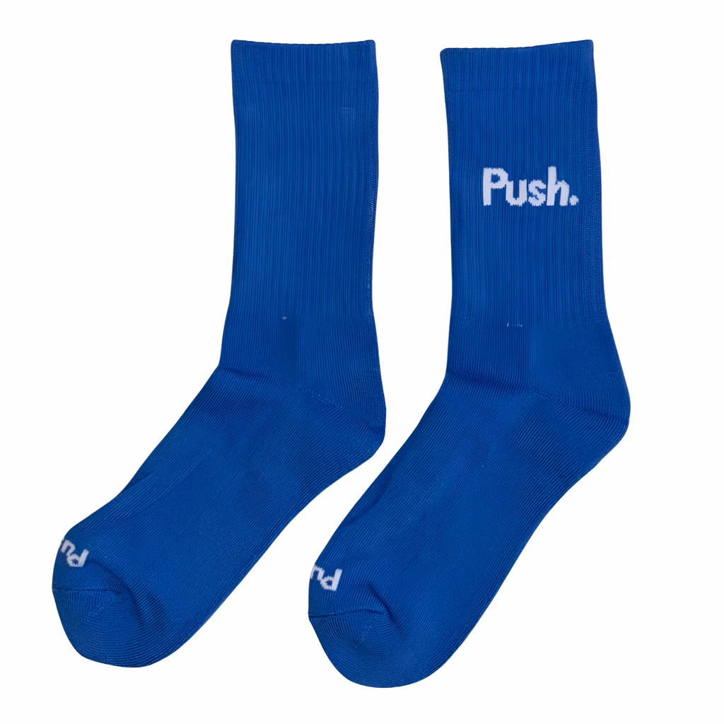 Pair of blue training socks with 'Push.' logo on a white background