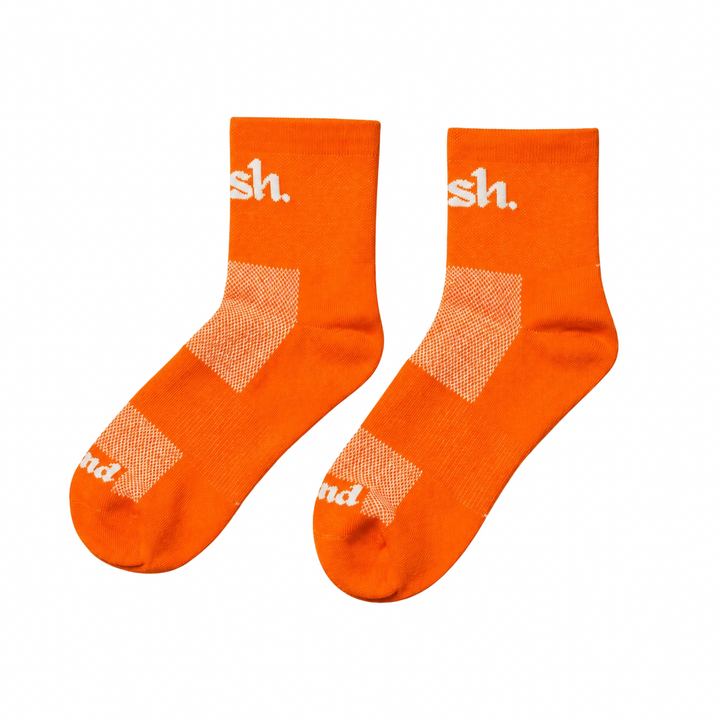 Push performance orange quarter length running socks with white text on a white background