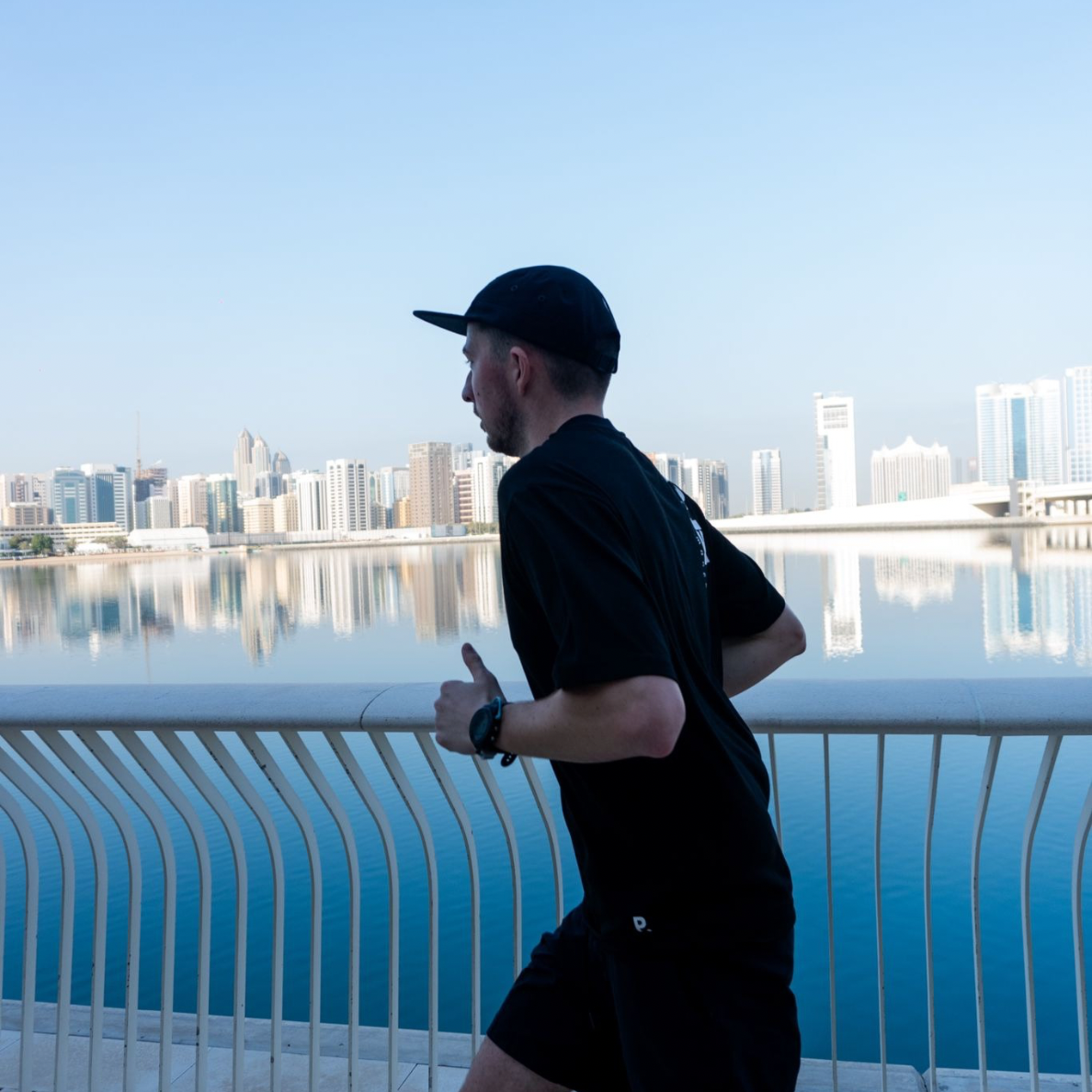 Runner wearing the black Core T-Shirt during an outdoor run.