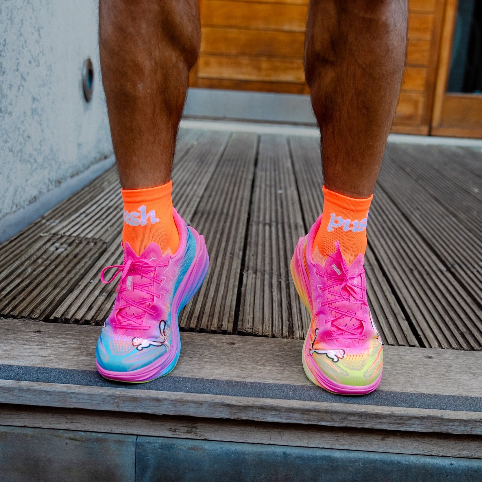 person wearing colourful running shoes with bright orange running socks