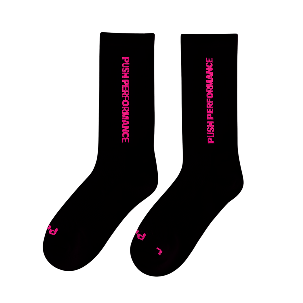 push performance black and pink anti-blister running socks on white flatlay background