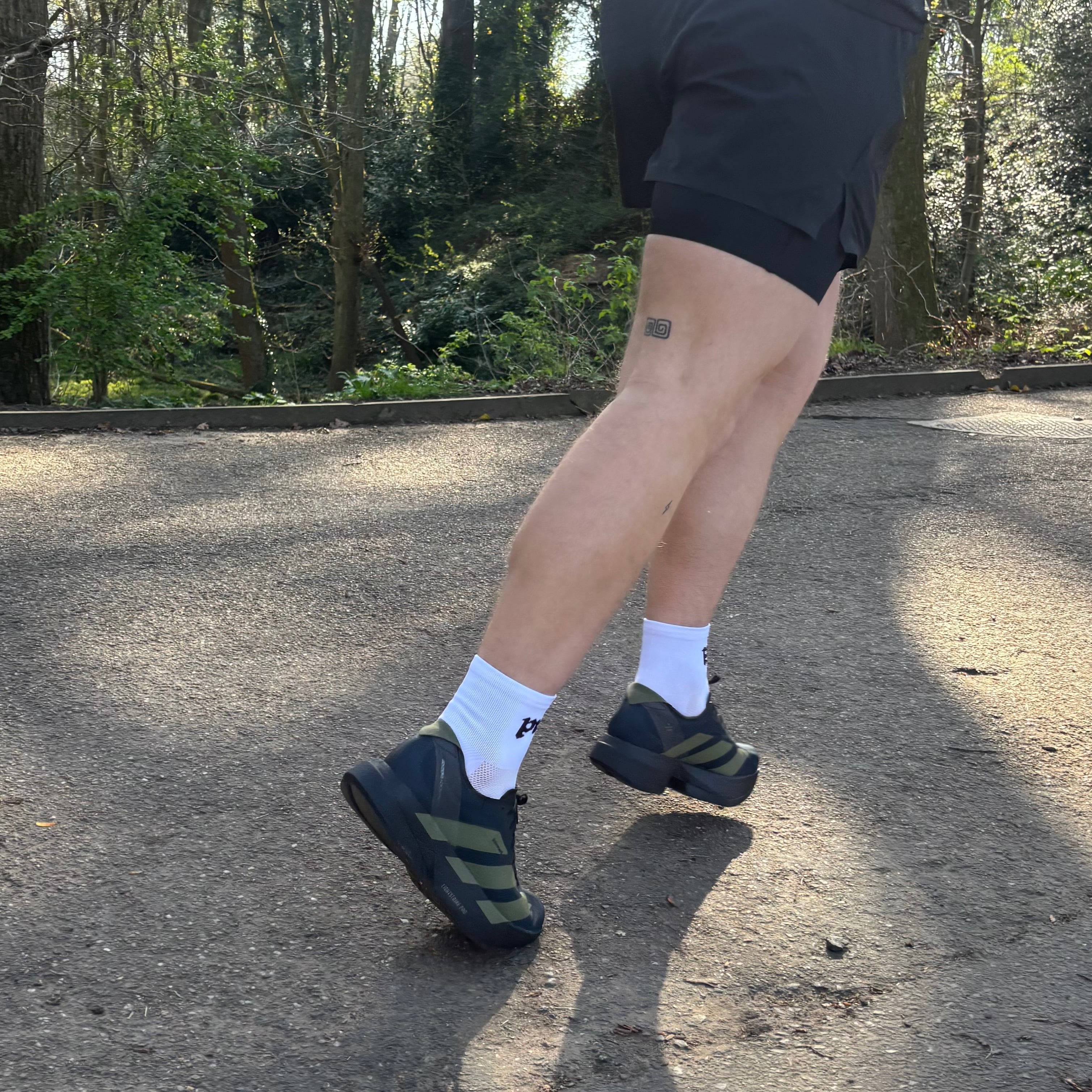 person running whilst wearing white running socks 