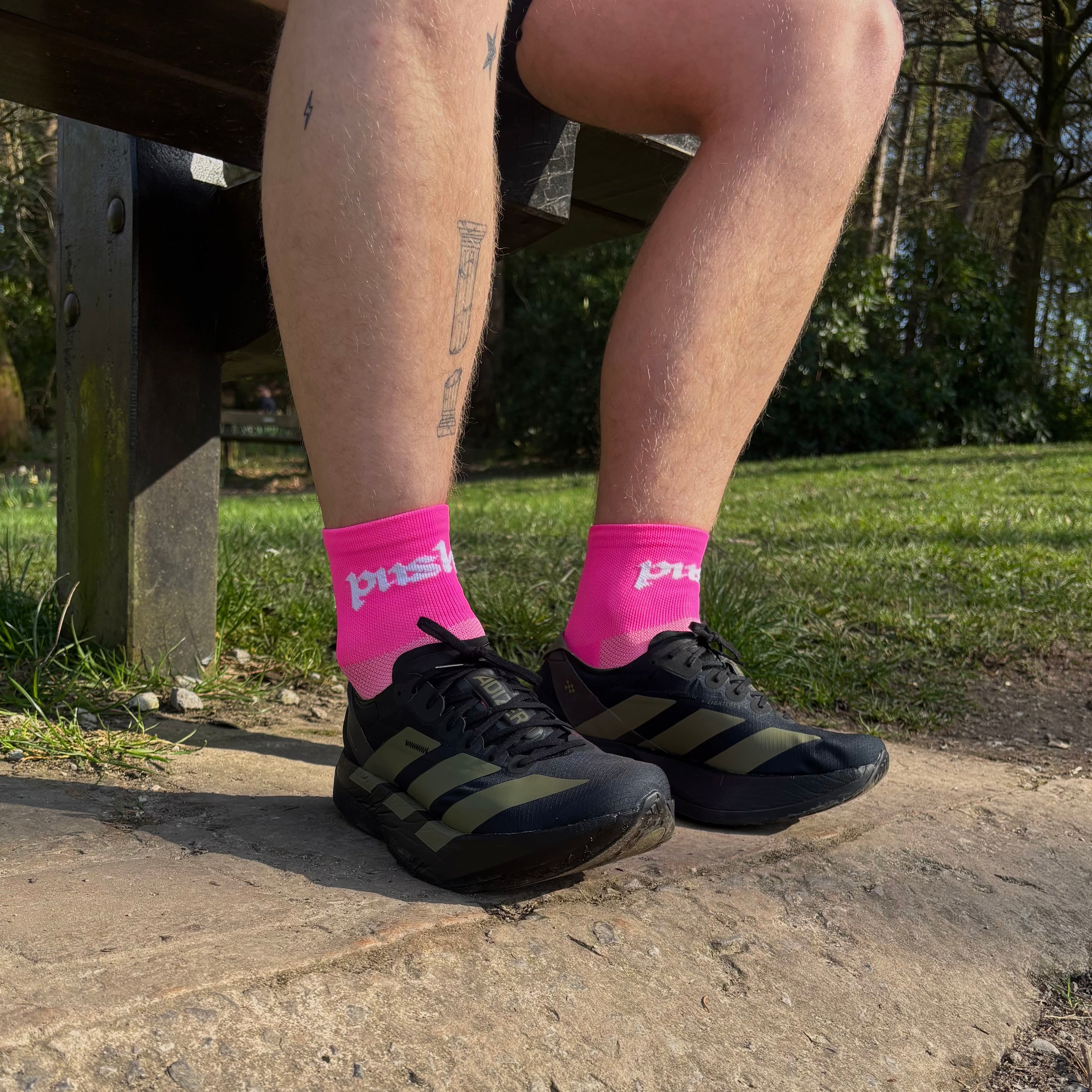 person sat on bench wearing pink running socks