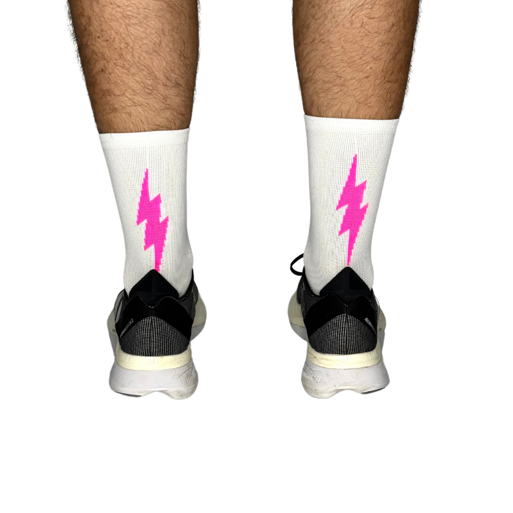 Athletic white socks featuring a bold pink lightning bolt pattern.