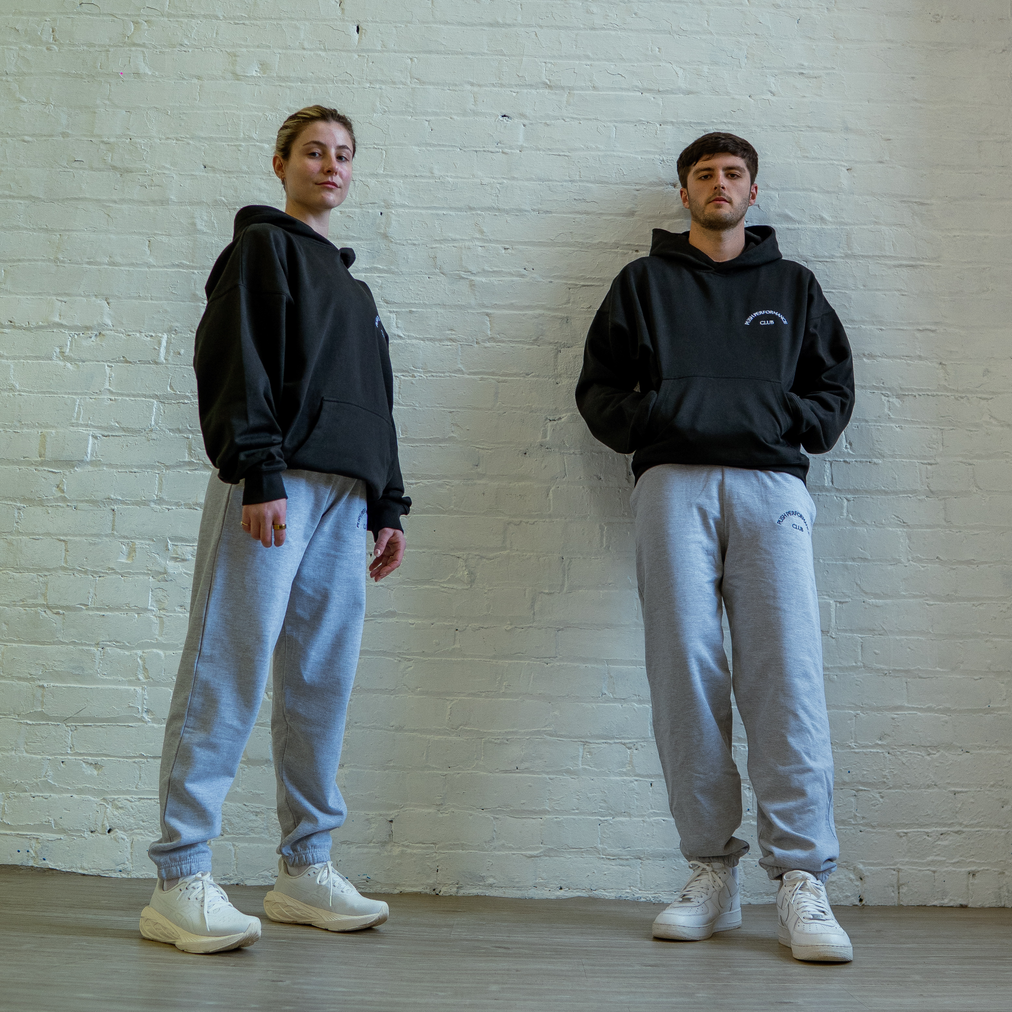 Essential Warm Up Hoodie by Push Performance styled in urban setting, fusing athletic wear with everyday streetwear aesthetic