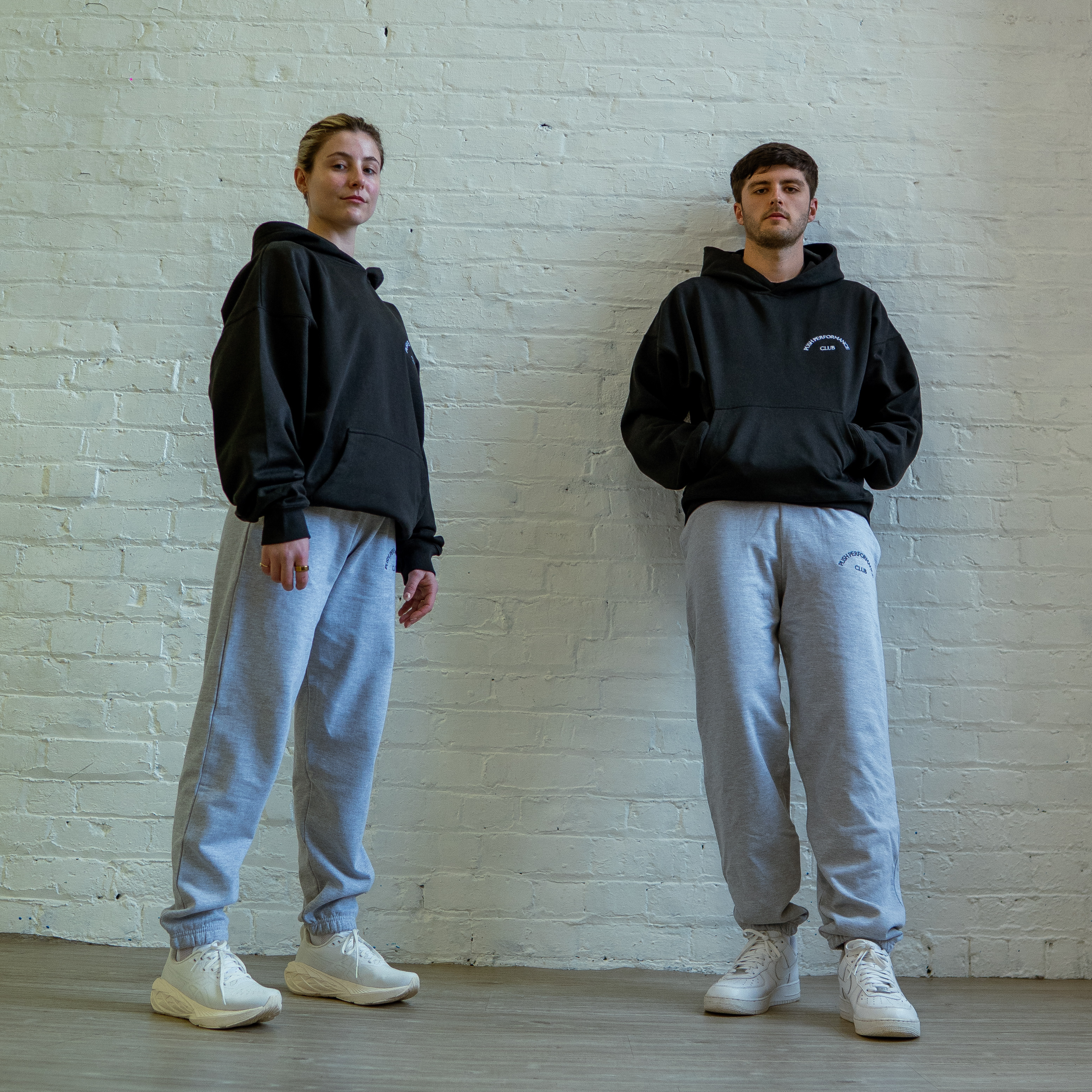 Essential Warm Up Hoodie by Push Performance styled in urban setting, fusing athletic wear with everyday streetwear aesthetic