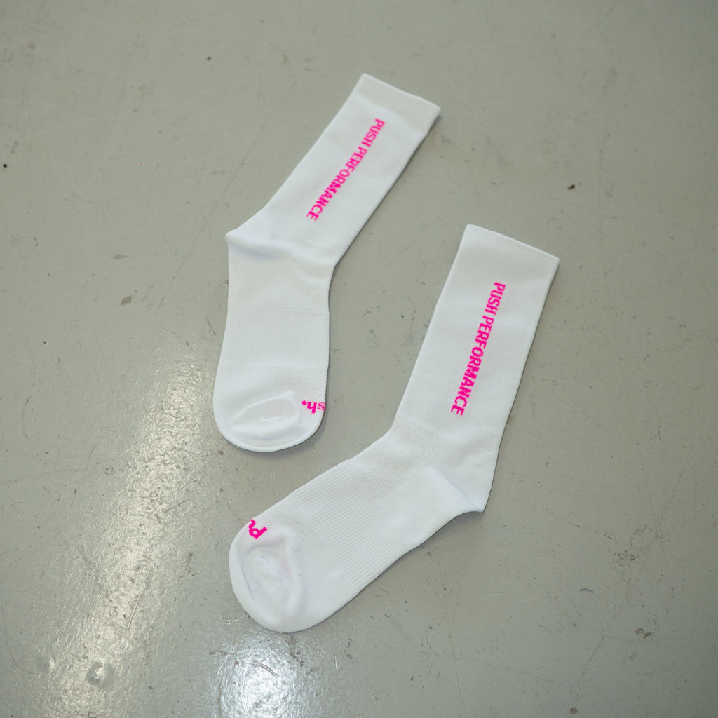 white/pink running socks in a flatlay style image. 