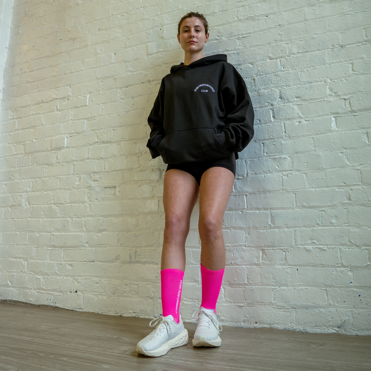 Athlete wearing hot pink Essential Endurance Socks, engineered for performance, grip and long-distance comfort