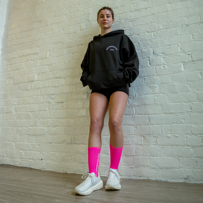 Athlete wearing hot pink Essential Endurance Socks, engineered for performance, grip and long-distance comfort