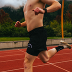 Running on track with black running shorts on.