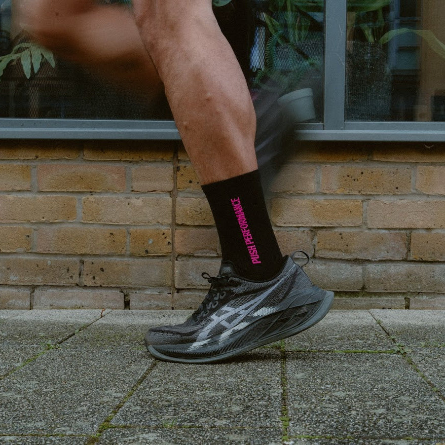 push performance black and pink anti-blister running socks on a runner 