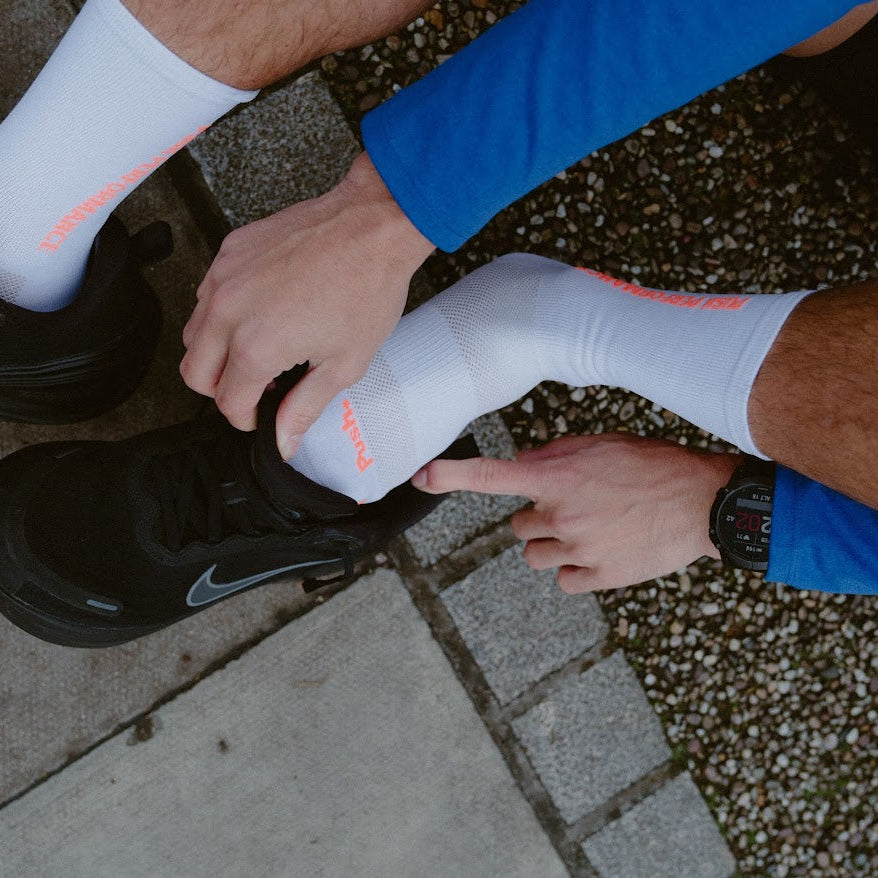 push performance white and orange  anti-blister running socks on runner