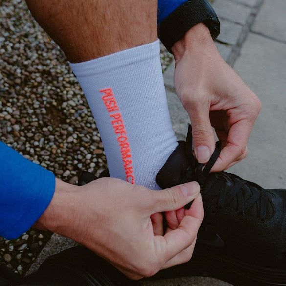 push performance white and orange  anti-blister running socks on runner